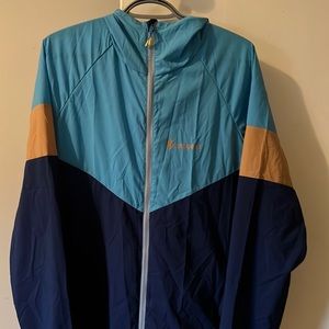 Blue multi colored Cotopaxi wind breaker jacket